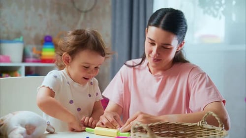 Mother and Child Play Together with Colorful Clay