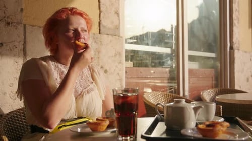 Woman Enjoying Pastel de Nata and Iced Tea