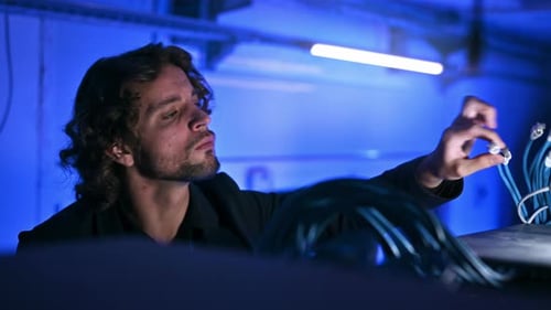 Man analysing cables in a data center