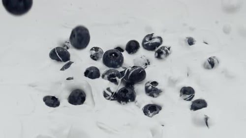 Blueberries Falling Into Creamy Yogurt in Slow Motion