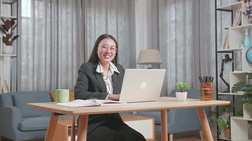 Woman Working on Laptop at Home Office