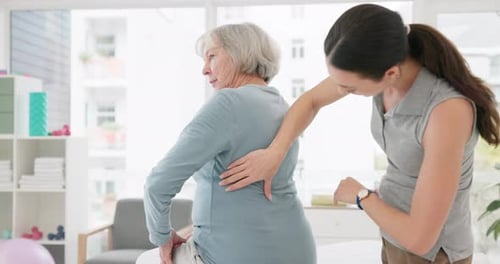 Woman Receiving Back Palpation from Healthcare Professional