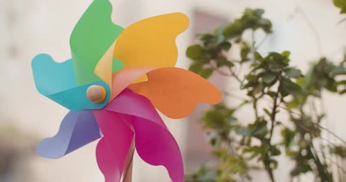 Close up view of a colorful pinwheel spinning with wind
