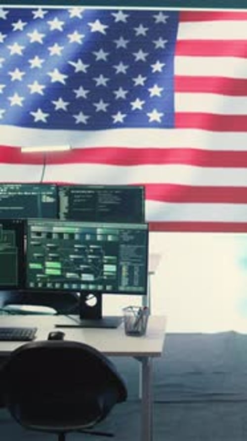 Computers Displaying Data with American Flag Backdrop