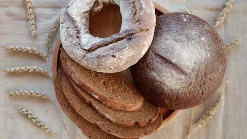 Wooden Plate with Dark Bread Overhead