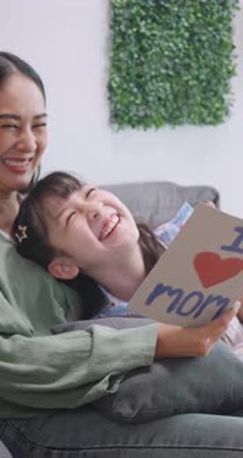 Girl Gives Handmade Birthday Card to Woman