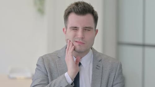 Portrait of Young Businessman with Toothache