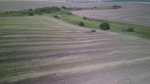 Tractor working on the field doing tillage with cultivator