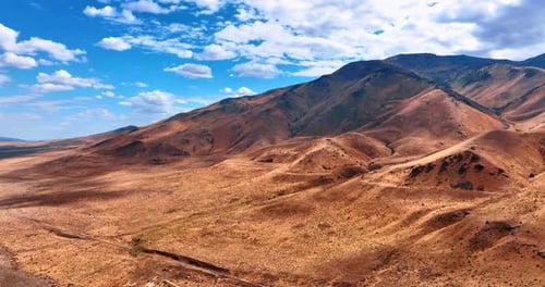 Scenic Aerial View of Golden Desert Hills and Mountains