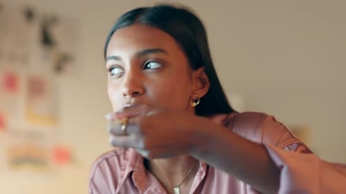Woman Eating Noodles with Chopsticks at Work