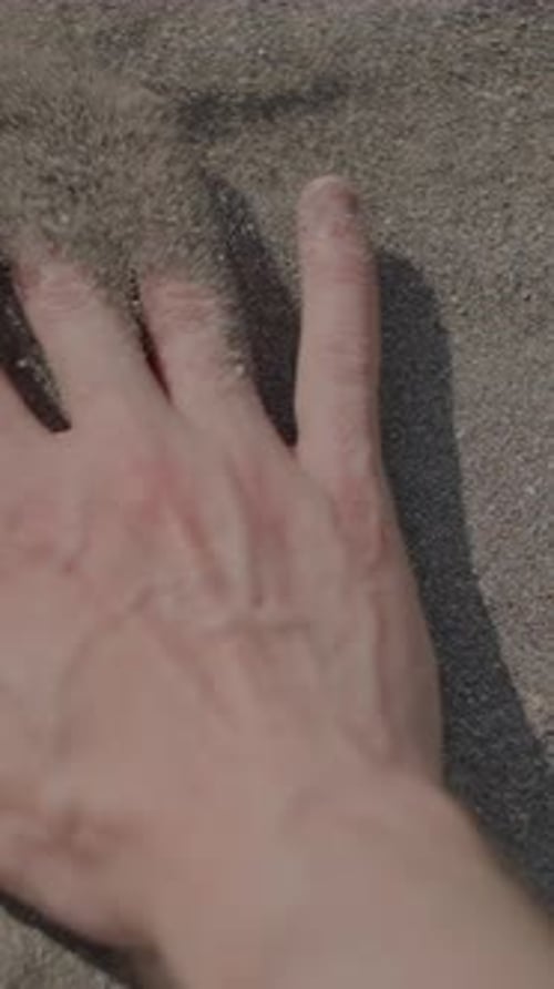A Hand Imprint in the Soft Sand on the Beautiful Beach Capturing a Moment of Serenity