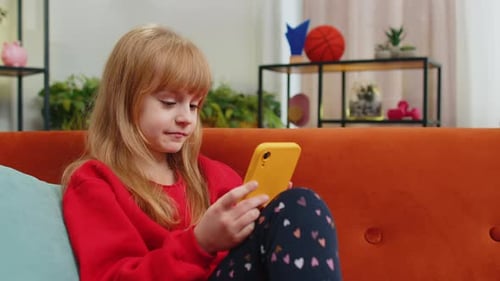 Girl Using Smartphone on Couch at Home