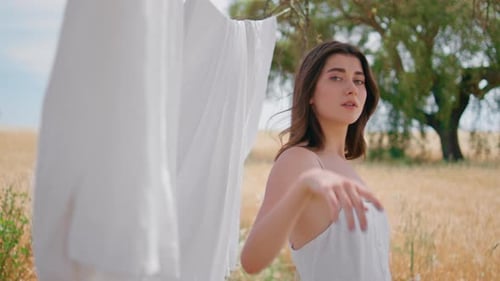 Beautiful Woman in Summer Dress Posing in Field
