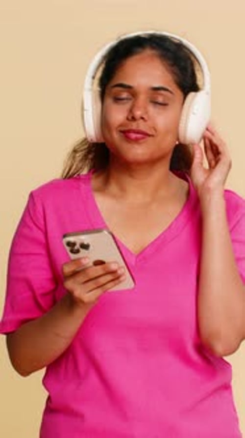 Woman Enjoys Music with Headphones and Mobile Phone