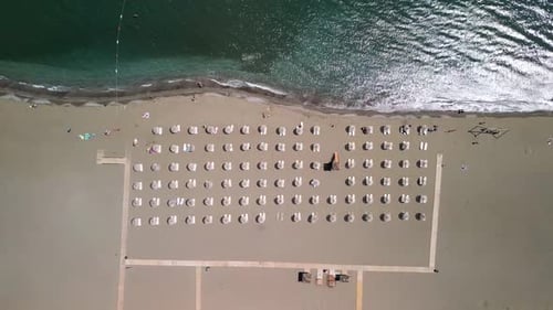 Aerial view of tranquil beach with umbrellas and chairs, Turkey.