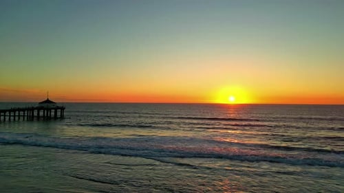 Drone Ascent Over Ocean Toward Manhattan Beach Pier at Sunset