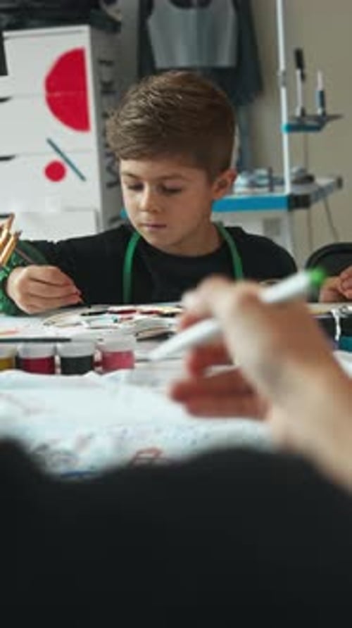 A Boy Draws in Class He Takes a Brush and Paints