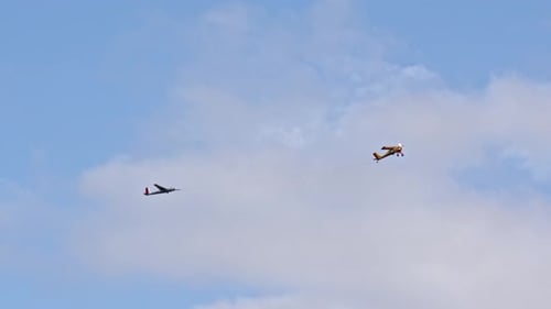 Bright Yellow Plane Pulls Glider on Cable Accelerating It to Required Speed so That Glider Can Fly