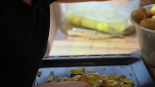 Woman Peeling Raw Potatoes Using A Stainless Vegetable Peeler. - Selective Focus