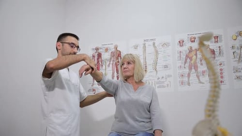 Medical Professional Examines Senior Woman's Arm