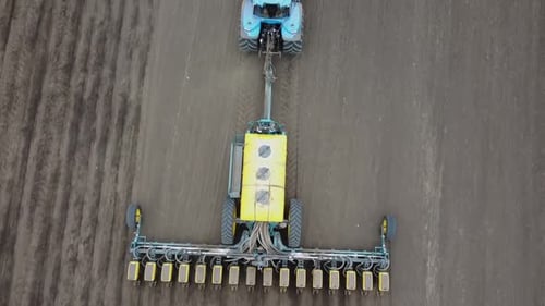 Blue tractor OA working on the field in Ukraine