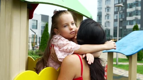 Heartwarming Motherdaughter Moment at Local Playground on a Sunny Afternoon