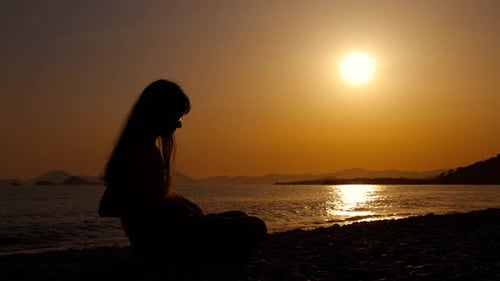 Silhouette of Pensive Teen Against Sea