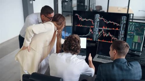 Team of stockbrokers works together in modern office at daytime