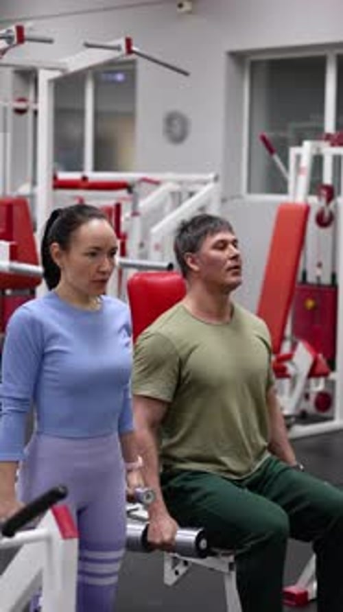 A Bicep Workout Together Man and Woman During Gym Workout at Gym