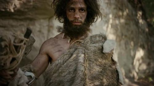 Wild Man Posing with Stone Axe in Cave