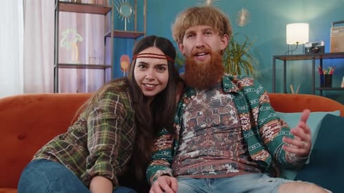 Happy Young Adult Couple Waving on Video Call