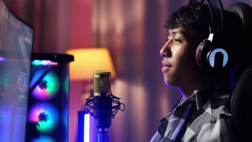 Asian Boy Streamer Lives Stream Playing Game On Computer, Talks On Microphone