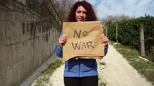 Woman Holds 'No War' Sign Outdoors