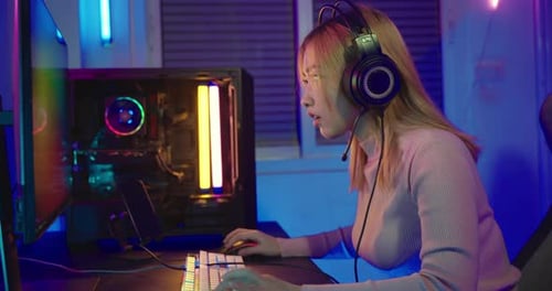 Woman Playing Computer Game with Neon Lights