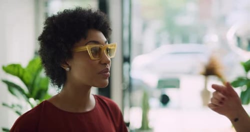 Stylish female friends trying on sunglasses in toronto clothing boutique