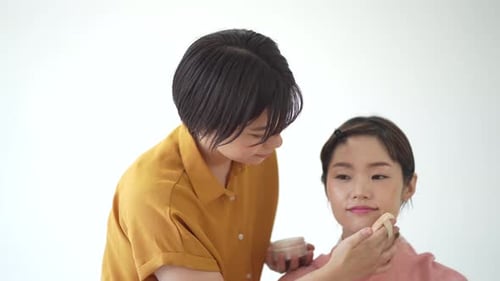 Makeup Artist Applying Powder on Model's Face