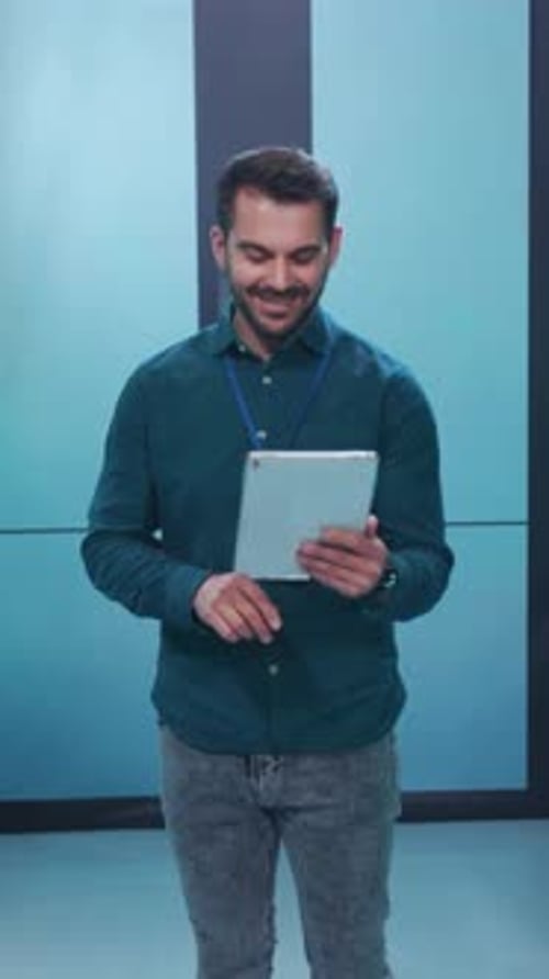 A Professional Man is Utilizing a Tablet Device Within a Contemporary and Modern Workspace