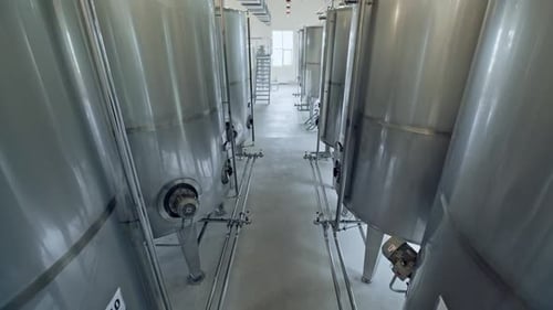 Rows of Tall Stainless Steel Tanks on Food Production Factory Viewed From Bottom to the Top
