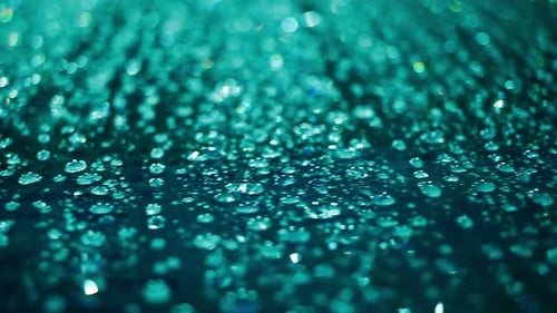 Abstract teal water droplets glistening bokeh background