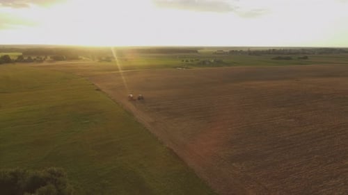 Tractor Working Field at Sunset Aerial