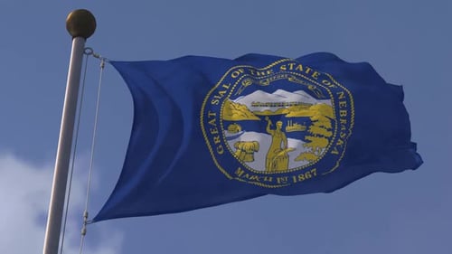 Nebraska State Flag Waving with Great Seal on a Clear Day