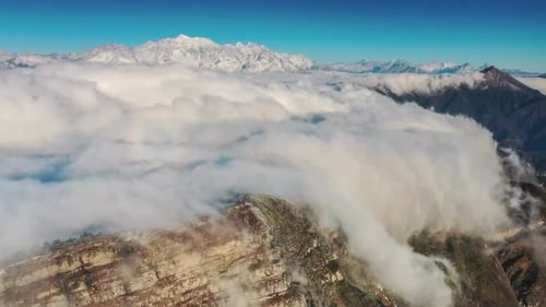 Aerial View of Mountain Range with Fog and Clouds