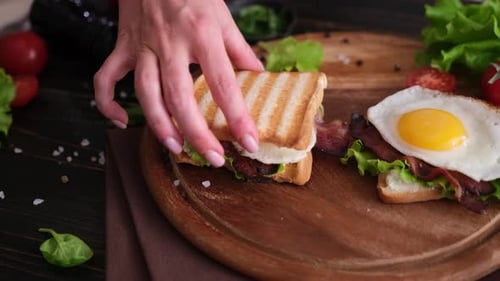 Preparing Breakfast Sandwich with Bacon and Egg