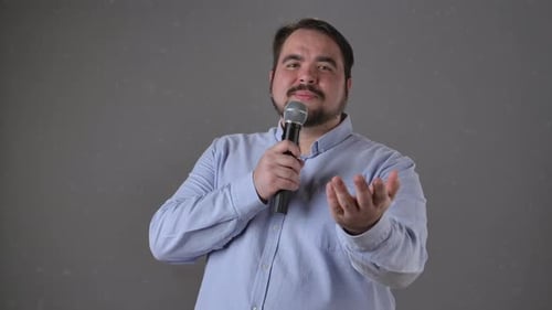 Speaker Engaging Audience with Microphone Presentation Gesture