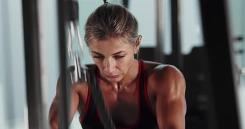 Athletic Woman Bodybuilder Doing Exercises in the Gym
