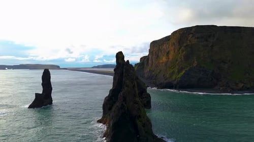 The three mountain peaks rising from the sea on the black sand beach of Reynisfjara