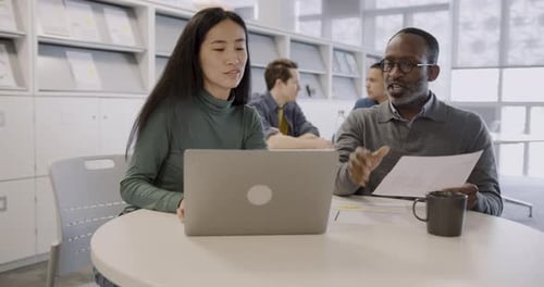 Colleagues Working on a Business Presentation Together in Office