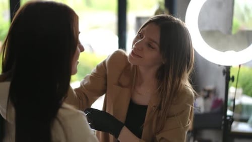 Makeup Artist Applies Makeup to Client in Salon