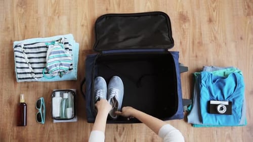 Hands Packing Travel Bag with Personal Stuff Adding