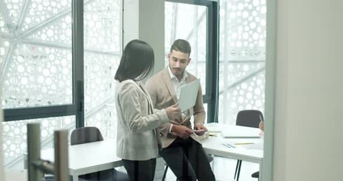 Professionals Collaborating on Laptop in Modern Office